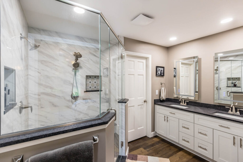 Lewis Center bathroom remodel with 45 degree shower and white vanity with black countertop