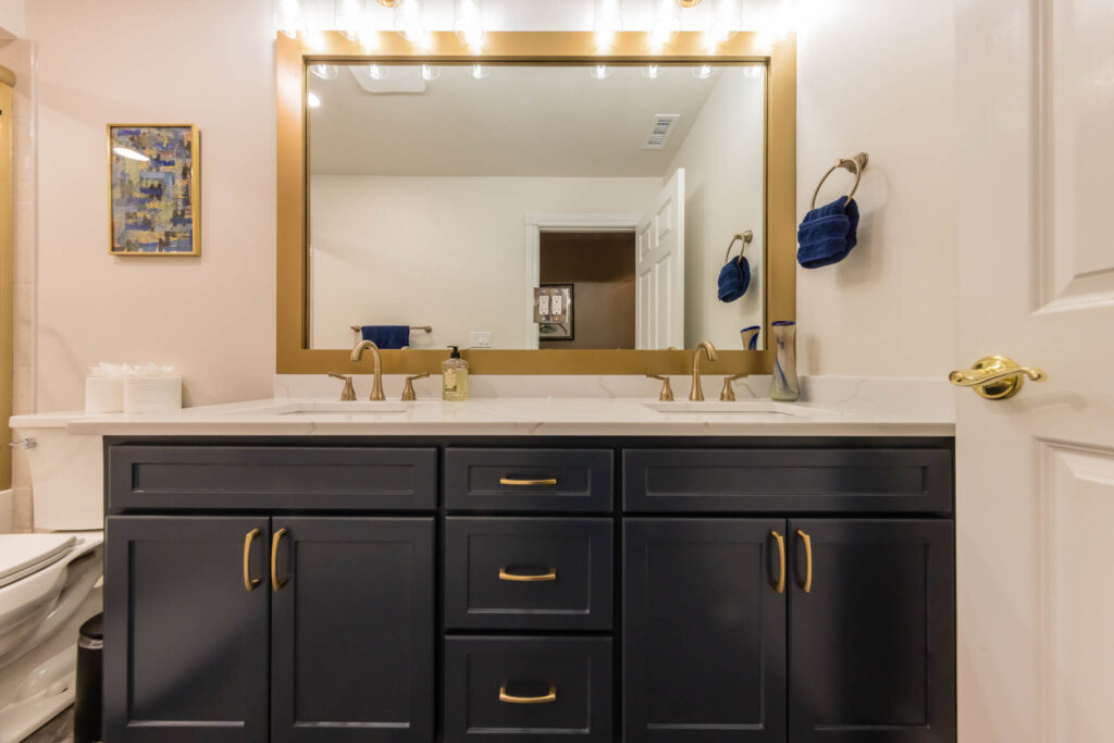 Dublin bathroom remodel with double blue sink cabinets and golden handles