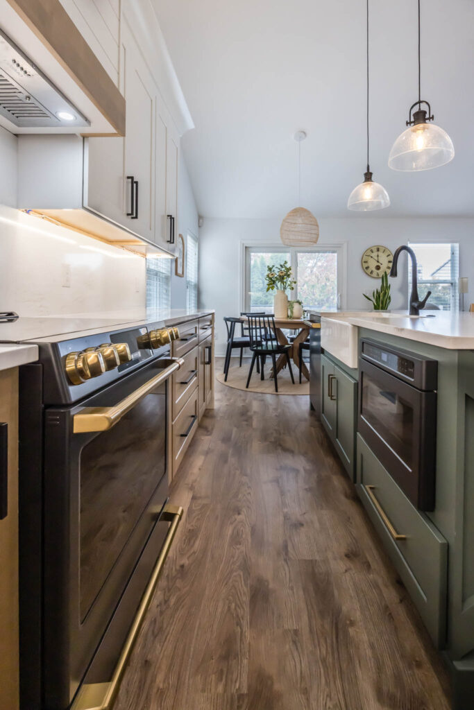 Westerville Kitchen remodel with gold and black stove next to green and brown cabinetry.